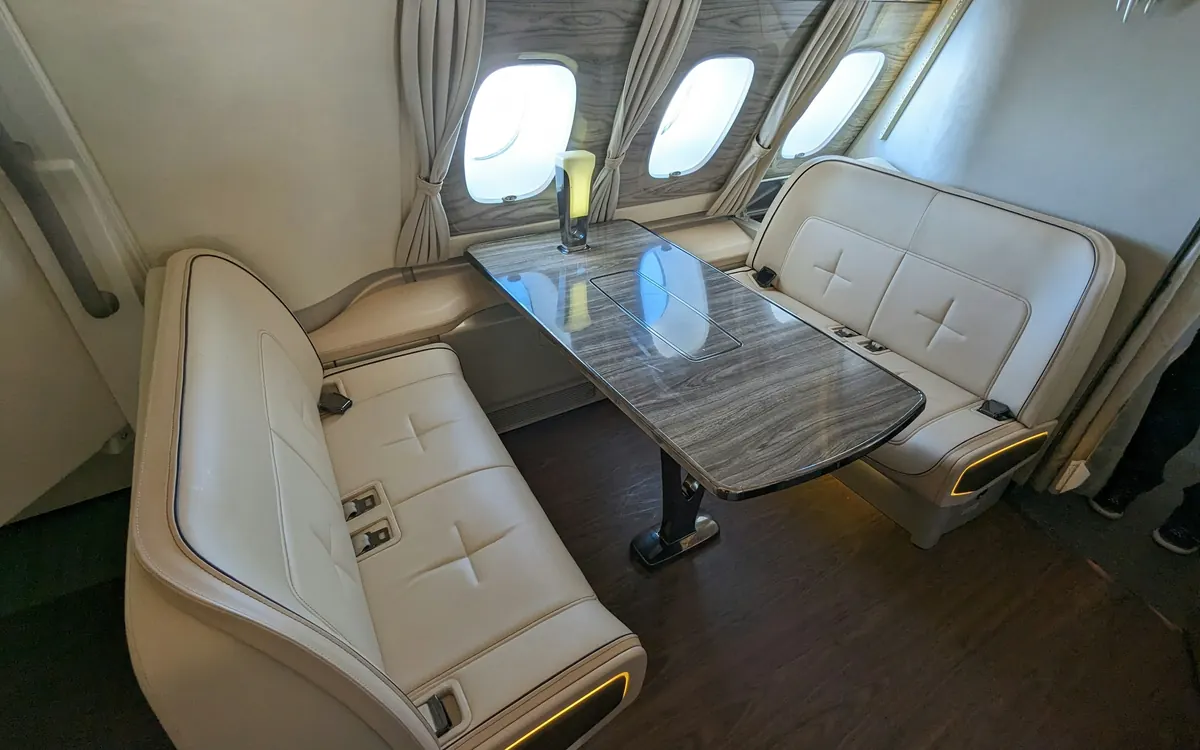 Club seating around a polished table in a private jet cabin